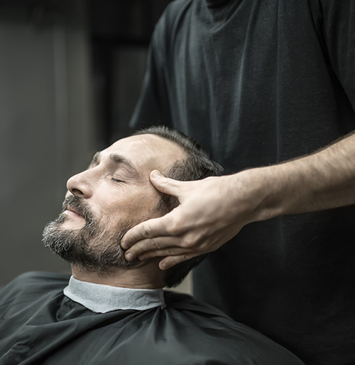 Man getting head massage at Arcadia Barber Shop
